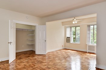 room with open closet and hardwood floors at Majestic Apartments in Washington, DC